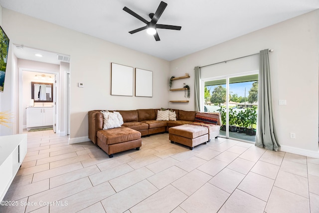 living area with light tile patterned floors, visible vents, baseboards, and ceiling fan