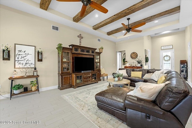 living room with beam ceiling, visible vents, baseboards, and a ceiling fan