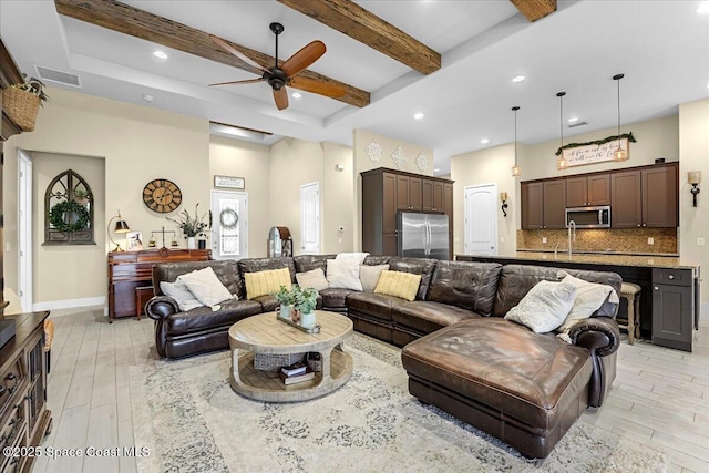 living room featuring a ceiling fan, visible vents, beam ceiling, recessed lighting, and light wood-type flooring