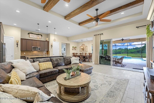 living room with recessed lighting, beamed ceiling, a ceiling fan, and a sunroom