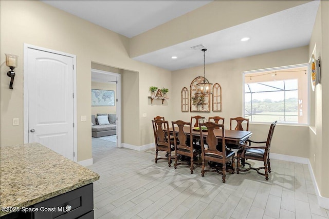 dining space with an inviting chandelier, light wood-style flooring, recessed lighting, and baseboards