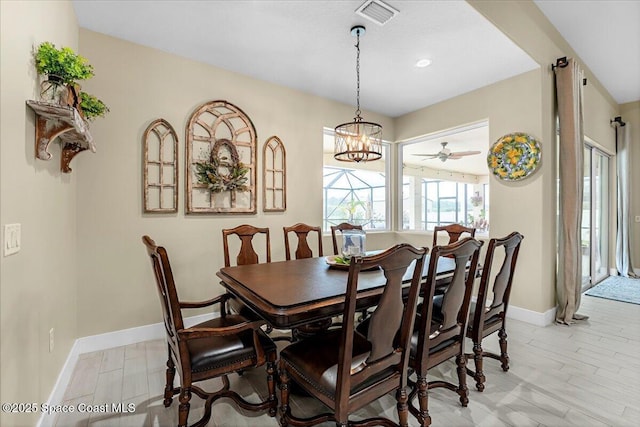 dining space featuring visible vents, baseboards, light wood-style floors, and a notable chandelier