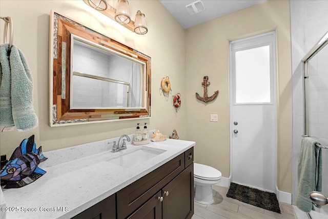 bathroom with visible vents, baseboards, toilet, an enclosed shower, and vanity