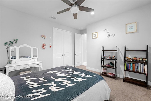 carpeted bedroom featuring a closet, visible vents, a ceiling fan, and baseboards