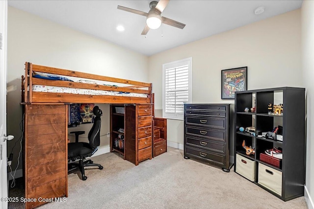 bedroom featuring baseboards, light colored carpet, and a ceiling fan