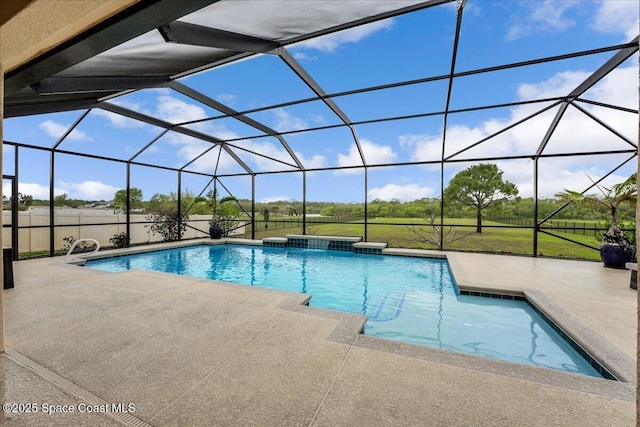 outdoor pool with glass enclosure and a patio area