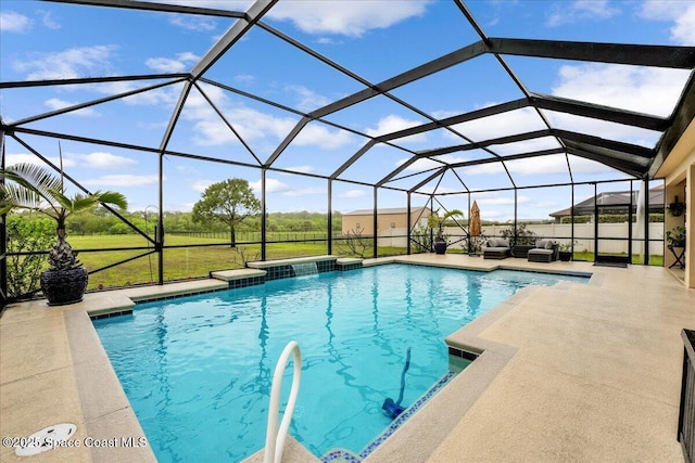 outdoor pool with a patio area, a lawn, and a lanai