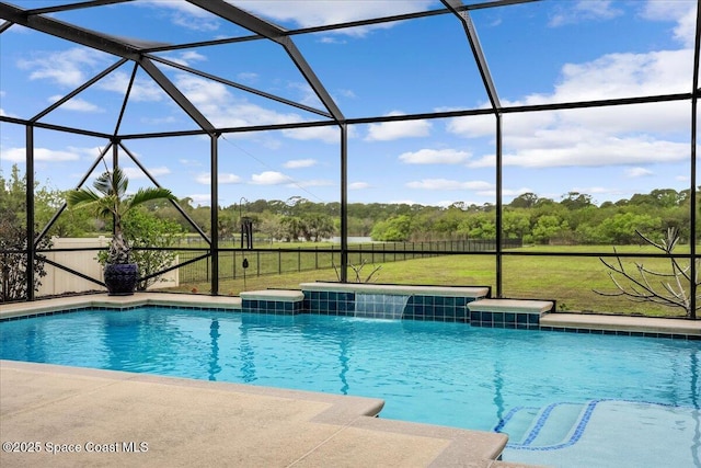 pool featuring glass enclosure, a lawn, and a patio