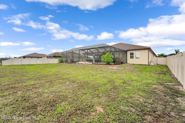 view of yard featuring a lanai and a fenced backyard