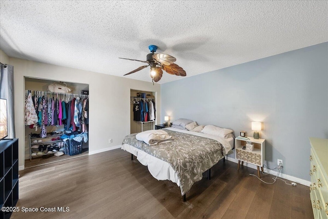 bedroom featuring baseboards, a textured ceiling, and wood finished floors