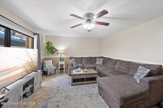 living area featuring a textured ceiling and ceiling fan