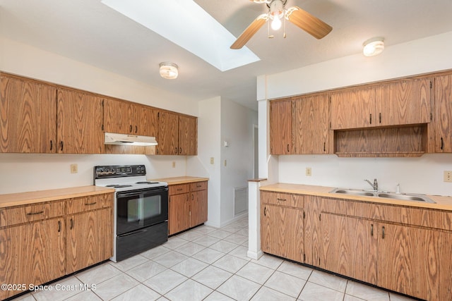 kitchen featuring under cabinet range hood, visible vents, range with electric stovetop, and light countertops