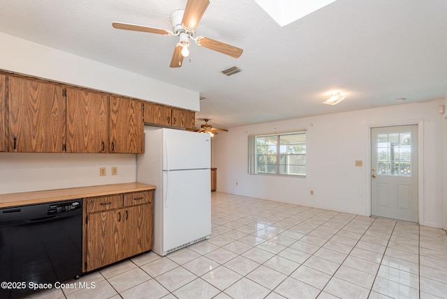 kitchen with a wealth of natural light, a ceiling fan, freestanding refrigerator, light countertops, and dishwasher