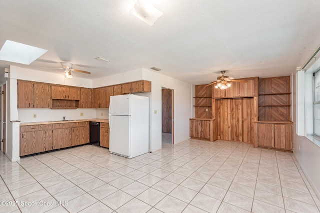 kitchen featuring dishwasher, visible vents, freestanding refrigerator, and ceiling fan