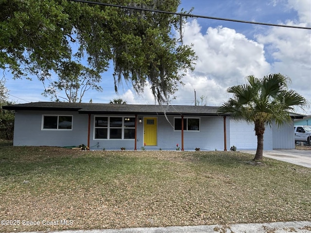 ranch-style house featuring a front yard, an attached garage, and concrete driveway