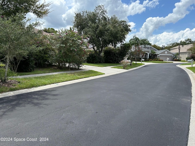 view of street featuring sidewalks, a residential view, and curbs