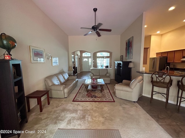 living room with carpet floors, high vaulted ceiling, recessed lighting, arched walkways, and ceiling fan