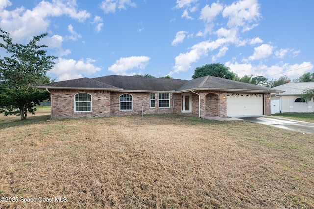 ranch-style home with roof with shingles, concrete driveway, a front yard, an attached garage, and brick siding