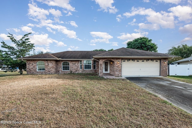 ranch-style home with a gate, fence, an attached garage, concrete driveway, and brick siding