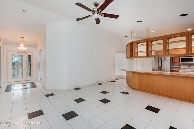 kitchen with light tile patterned floors, tasteful backsplash, appliances with stainless steel finishes, and light countertops