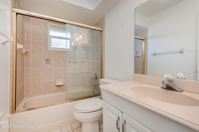 bathroom with tile patterned floors, enclosed tub / shower combo, toilet, and vanity