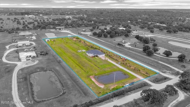 birds eye view of property featuring a rural view