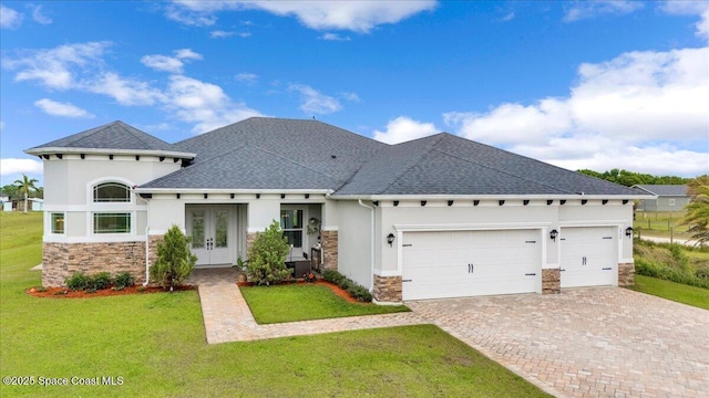 view of front of home featuring stucco siding, driveway, french doors, a front yard, and a garage