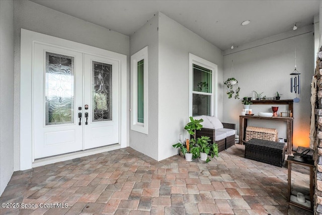 entrance to property with stucco siding and french doors