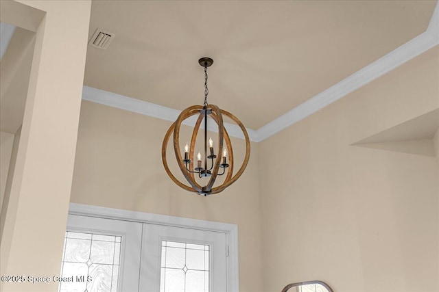 details featuring visible vents, an inviting chandelier, and crown molding