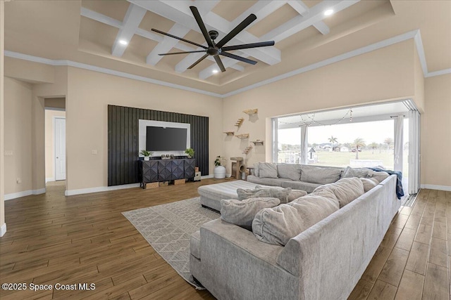 living area with a high ceiling, wood finished floors, a ceiling fan, and coffered ceiling