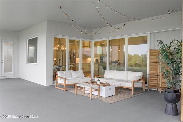 sunroom featuring a chandelier