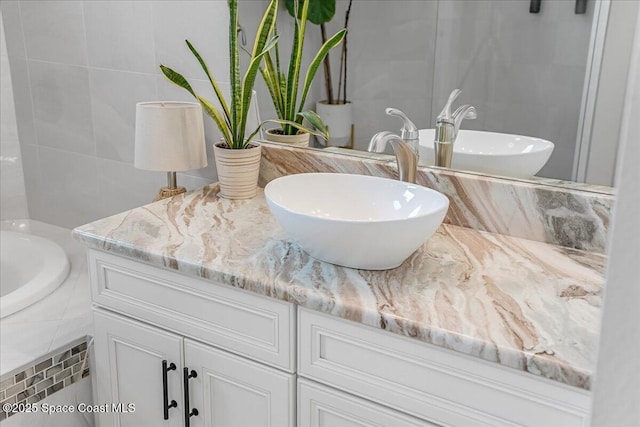 bathroom featuring tile walls and vanity