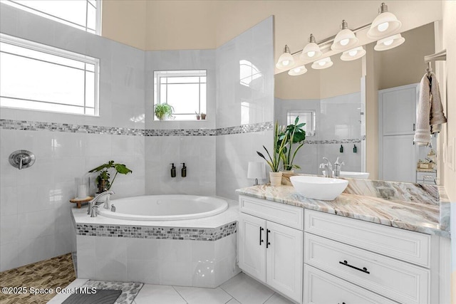 full bathroom featuring vanity, tile patterned floors, a bath, and walk in shower