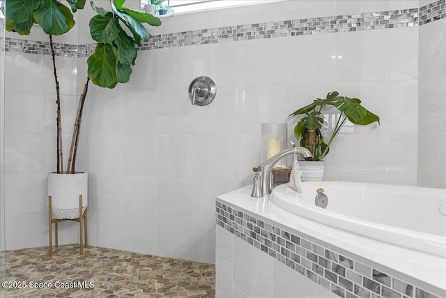 full bathroom with a tile shower, tile walls, and a garden tub