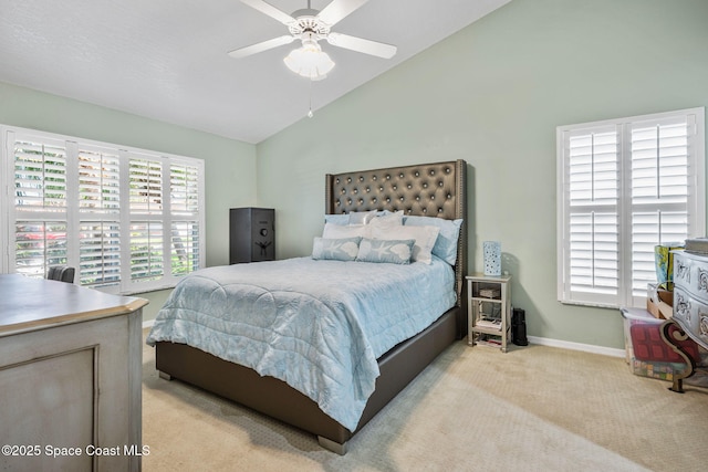 bedroom featuring vaulted ceiling, multiple windows, baseboards, and light carpet