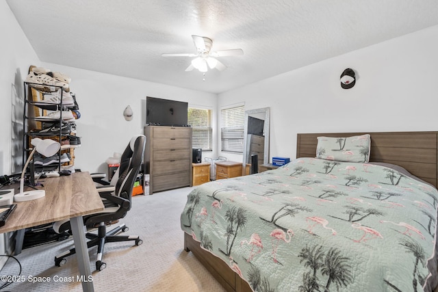 carpeted bedroom with a textured ceiling and a ceiling fan