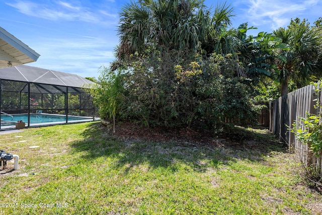 view of yard featuring a lanai, a fenced backyard, and a fenced in pool