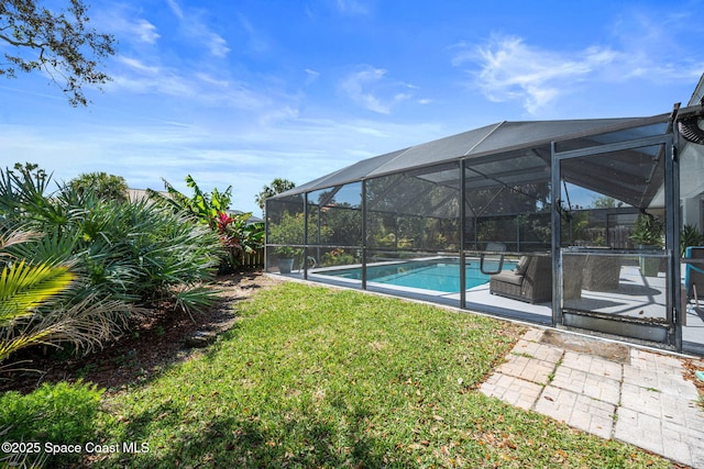 view of yard with a lanai, a patio area, and an outdoor pool