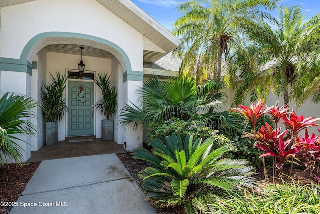 property entrance with stucco siding