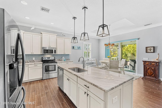 kitchen featuring a sink, visible vents, wood finish floors, and appliances with stainless steel finishes