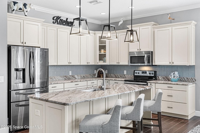 kitchen with ornamental molding, a sink, tasteful backsplash, stainless steel appliances, and dark wood-style flooring