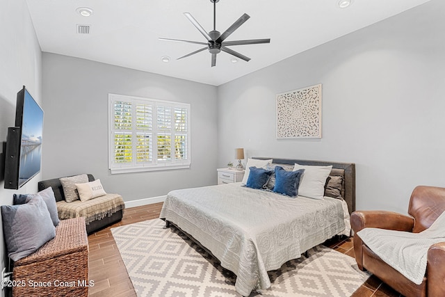 bedroom with visible vents, ceiling fan, baseboards, and wood finished floors