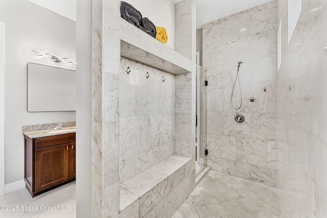 full bathroom featuring vanity, marble finish floor, and a marble finish shower