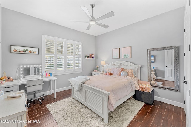 bedroom with baseboards, a ceiling fan, and wood tiled floor