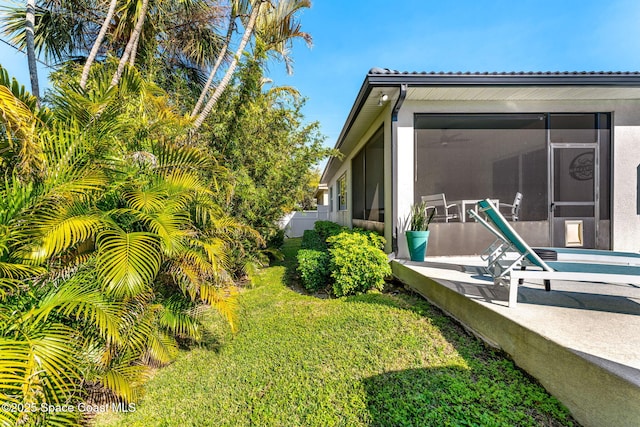 view of yard featuring a sunroom