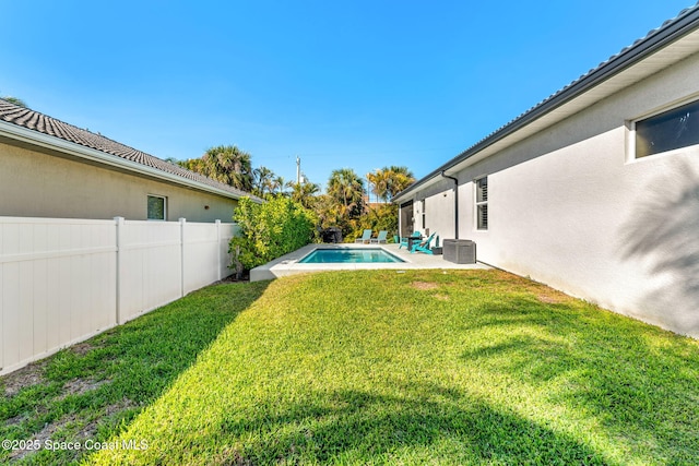 view of yard featuring a fenced in pool, a fenced backyard, and a patio area