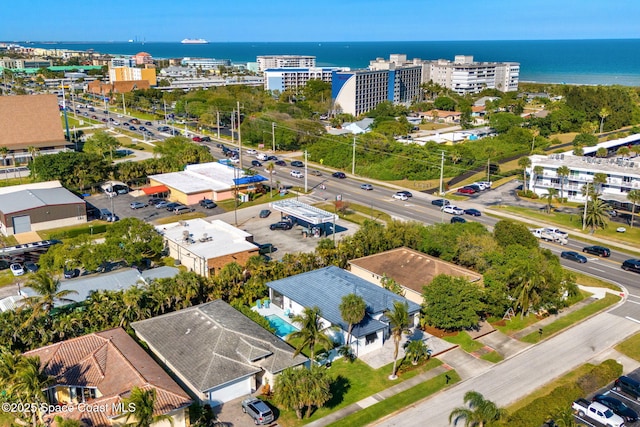 birds eye view of property with a city view and a water view