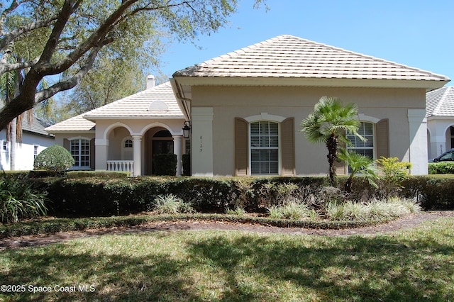 view of front of home with a front yard and stucco siding