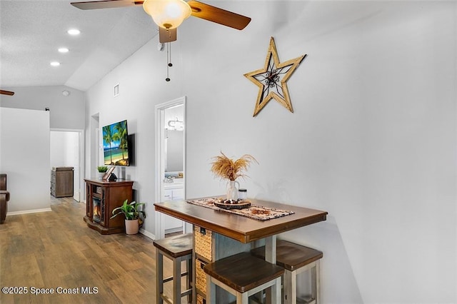 dining area with visible vents, a ceiling fan, wood finished floors, recessed lighting, and vaulted ceiling