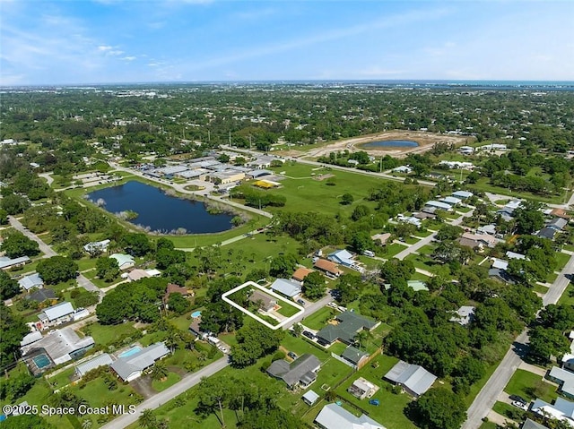 drone / aerial view with a water view and a residential view